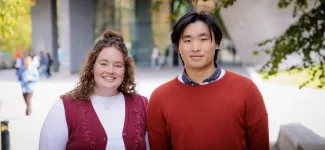 Graduates Kendrick Cooke and Sean Leong, standing outside the Pharmaceutical Sciences Building.
