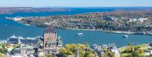 A bird's-eye shot of the Fairmont Le Chateau Frontenac hotel in Quebec City, on a sunny day.