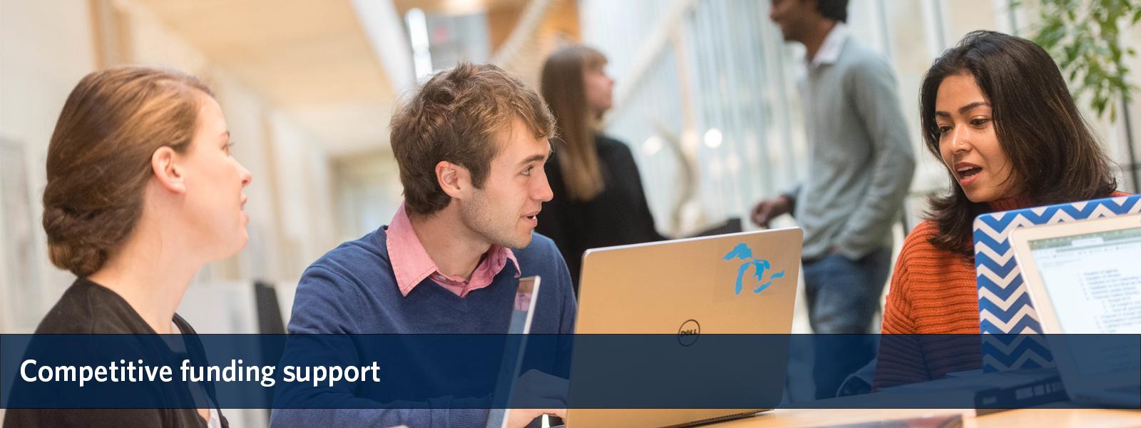 Three students conversing at a table, overlaid with the text "competitive funding support".