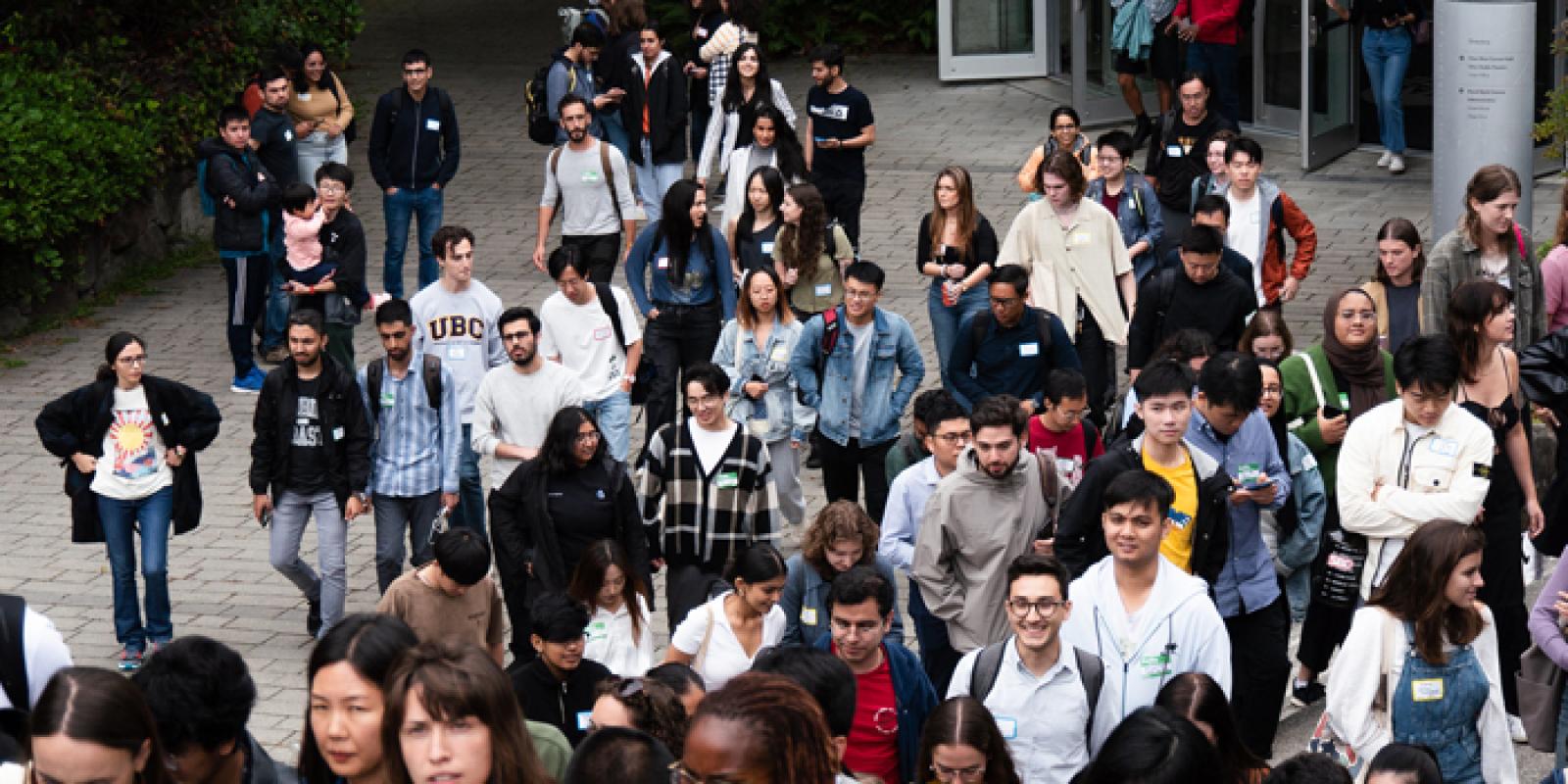 An overhead view of a crowd of students exiting the UBC Chan Centre.