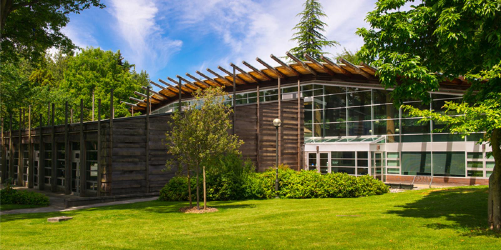 The exterior of the UBC First Nations Longhouse on a sunny day.